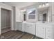 Bathroom boasts double vanity, white cabinets, and gray flooring at 230 Mcnair Rd, Whiteland, IN 46184