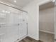Clean bathroom with a large glass shower and a spacious closet at 230 Mcnair Rd, Whiteland, IN 46184