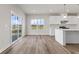 Kitchen dining area with vinyl plank flooring and sliding glass door to patio at 230 Mcnair Rd, Whiteland, IN 46184
