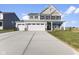 Move-in ready two-story home with a three-car garage and landscaped lawn at 230 Mcnair Rd, Whiteland, IN 46184