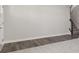 Foyer with gray walls, wood-look flooring, and carpeted stairs at 230 Mcnair Rd, Whiteland, IN 46184