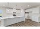 Bright kitchen featuring white cabinetry, quartz countertops, and an island at 230 Mcnair Rd, Whiteland, IN 46184