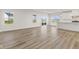 Open concept kitchen and living area with wood-look floors at 230 Mcnair Rd, Whiteland, IN 46184