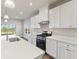Modern kitchen with white cabinets, stainless steel appliances, and quartz countertops at 230 Mcnair Rd, Whiteland, IN 46184