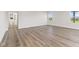Spacious living room with wood-look floors and access to a bathroom at 230 Mcnair Rd, Whiteland, IN 46184