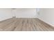 Spacious living room with wood-look floors and access to a hallway at 230 Mcnair Rd, Whiteland, IN 46184