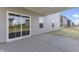 Covered patio with sliding glass doors and a view of the homes behind it at 230 Mcnair Rd, Whiteland, IN 46184