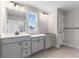 Modern bathroom with double vanity and gray cabinets at 250 Mcnair Rd, Whiteland, IN 46184