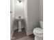 Clean powder room with pedestal sink, toilet, and dark vanity hardware at 250 Mcnair Rd, Whiteland, IN 46184
