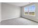Bright bedroom featuring a large window and grey carpet at 250 Mcnair Rd, Whiteland, IN 46184