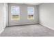 Bright bedroom with grey carpet, two large windows, and neutral walls at 250 Mcnair Rd, Whiteland, IN 46184