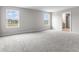 Bedroom with two windows, grey carpet, and access to a bathroom at 250 Mcnair Rd, Whiteland, IN 46184