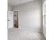 Simple bedroom with grey carpet, white door, and access to another room at 250 Mcnair Rd, Whiteland, IN 46184