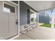 Front porch with gray siding, stone accents, and a light beige door at 250 Mcnair Rd, Whiteland, IN 46184