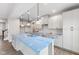 Modern kitchen with white cabinets, blue quartz island, and pendant lights at 250 Mcnair Rd, Whiteland, IN 46184