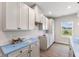 White kitchen cabinets, quartz countertops, and a view of the backyard at 250 Mcnair Rd, Whiteland, IN 46184
