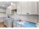 White kitchen cabinets and quartz countertops with under cabinet lighting at 250 Mcnair Rd, Whiteland, IN 46184