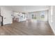 Open concept kitchen features white shaker cabinets, island, and grey vinyl flooring at 250 Mcnair Rd, Whiteland, IN 46184