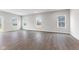 Living room with hardwood floors and multiple windows offering natural light at 250 Mcnair Rd, Whiteland, IN 46184