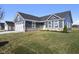 Gray siding two-car garage and stone accents characterize this charming craftsman style home at 432 Charles Freer Ln, Whiteland, IN 46184