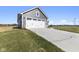 Two car garage with white doors and gray siding on a craftsman style home at 432 Charles Freer Ln, Whiteland, IN 46184