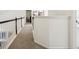 Upstairs hallway with carpeted flooring and dark wood railings at 13438 Silverstone Dr, Fishers, IN 46037