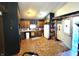 Cozy kitchen with wood cabinets, tiled floors, and a full suite of appliances at 290 W Washington St, Martinsville, IN 46151