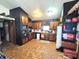 Galley kitchen with wood cabinets and tiled floors. Includes a refrigerator and microwave at 290 W Washington St, Martinsville, IN 46151
