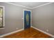Light grey walls, hardwood floors, and a blue door at 7060 S Meridian St, Indianapolis, IN 46217