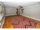Hardwood floors, red and brown zig zag rug, and kitchen view at 7060 S Meridian St, Indianapolis, IN 46217