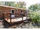 Wooden deck overlooks backyard with brick house at 7060 S Meridian St, Indianapolis, IN 46217