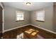 Bright bedroom featuring hardwood floors and two windows at 7060 S Meridian St, Indianapolis, IN 46217