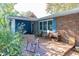 Brick home with wooden deck, chairs, and landscaping at 7060 S Meridian St, Indianapolis, IN 46217