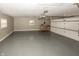 Large garage, gray floor, overhead door and shelving at 7060 S Meridian St, Indianapolis, IN 46217