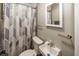Clean bathroom, shower with curtain, white sink and toilet at 7060 S Meridian St, Indianapolis, IN 46217