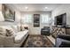 Comfortable sitting area with a white couch, armchairs, and a large TV at 456 Monon Way Dr, Carmel, IN 46032