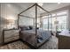 Main bedroom with metal canopy bed and built-in shelving at 456 Monon Way Dr, Carmel, IN 46032