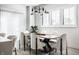 Bright dining room with a wood table, six chairs, and a modern chandelier at 456 Monon Way Dr, Carmel, IN 46032