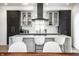 Modern kitchen features white countertops, a large island, and sleek dark cabinetry at 456 Monon Way Dr, Carmel, IN 46032