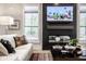 Living room with fireplace, large TV, and comfortable seating at 456 Monon Way Dr, Carmel, IN 46032