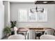 Modern dining room with wood table and six light-grey upholstered chairs at 456 Monon Way Dr, Carmel, IN 46032