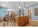 Open kitchen with island, wooden cabinets, and view into living room at 512 S Cherry St, Westfield, IN 46074