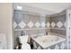 Bathroom with a jetted tub and gray diamond patterned tile at 1120 Lexington Ave, Indianapolis, IN 46203