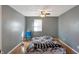 Bedroom with grey walls, ceiling fan, and hardwood floors at 1120 Lexington Ave, Indianapolis, IN 46203