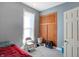 Bedroom with grey walls, red bedding, and built-in closet at 1120 Lexington Ave, Indianapolis, IN 46203