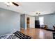 Main bedroom with hardwood floors, ceiling fan, and access to bathroom at 1120 Lexington Ave, Indianapolis, IN 46203