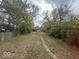 Large backyard with a grassy area and mature trees at 3221 E 38Th St, Indianapolis, IN 46218