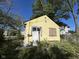 Yellow bungalow with boarded-up window at 3221 E 38Th St, Indianapolis, IN 46218