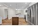 Modern kitchen with island, stainless steel appliances, and hardwood floors at 9562 N Gasburg Rd, Mooresville, IN 46158
