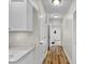 Hallway with laundry room and white cabinets at 9562 N Gasburg Rd, Mooresville, IN 46158